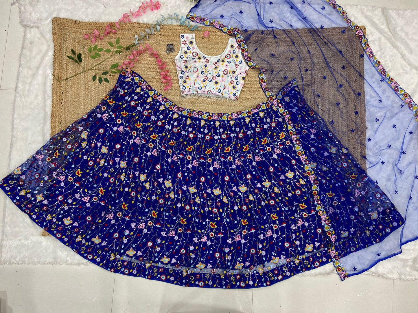 Demanding Net Embellished Blue Color Lehenga Choli