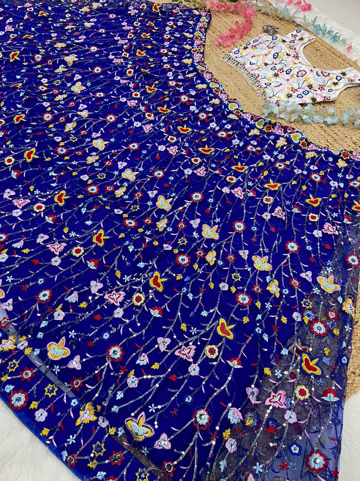 Demanding Net Embellished Blue Color Lehenga Choli