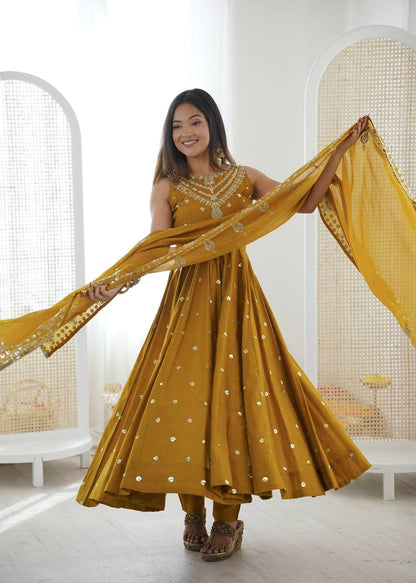 Haldi Wear Mustard Color Roman Silk Arti Chauhan Anarkali Gown Set
